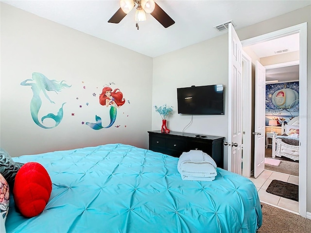 tiled bedroom featuring ceiling fan