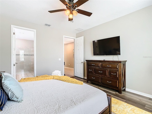 bedroom with hardwood / wood-style flooring, ensuite bath, and ceiling fan