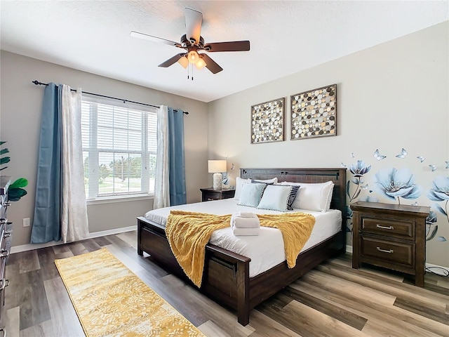 bedroom featuring ceiling fan and hardwood / wood-style flooring