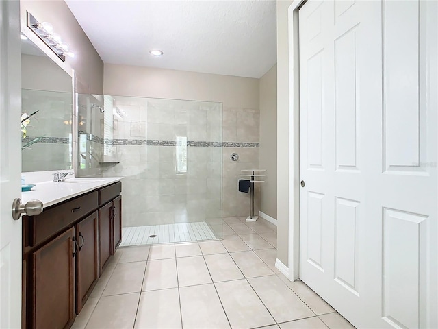 bathroom with tile patterned flooring, vanity, and an enclosed shower