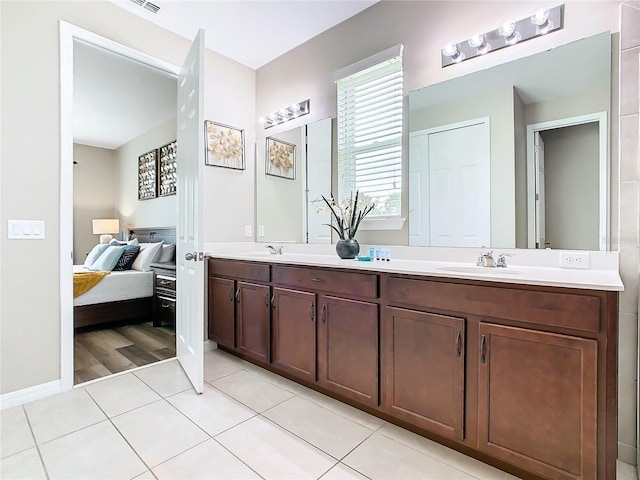 bathroom with dual vanity and hardwood / wood-style flooring