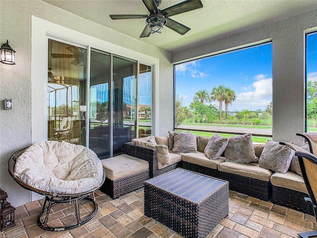 sunroom / solarium featuring ceiling fan