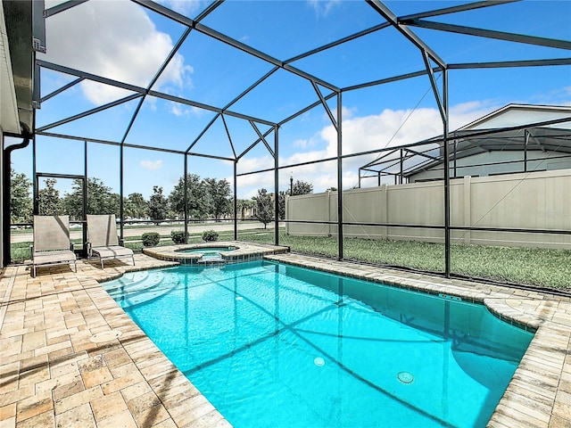 view of swimming pool featuring an in ground hot tub, glass enclosure, and a patio area