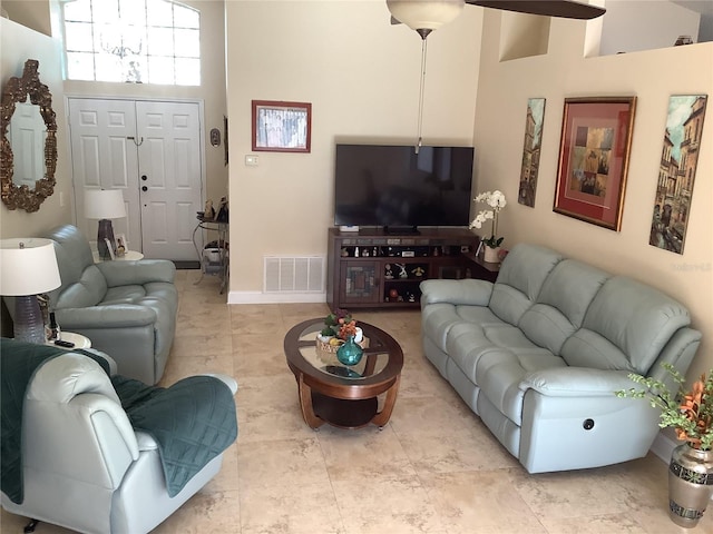 living room featuring a high ceiling