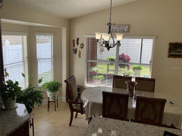 dining area featuring lofted ceiling, light tile patterned floors, plenty of natural light, and a textured ceiling