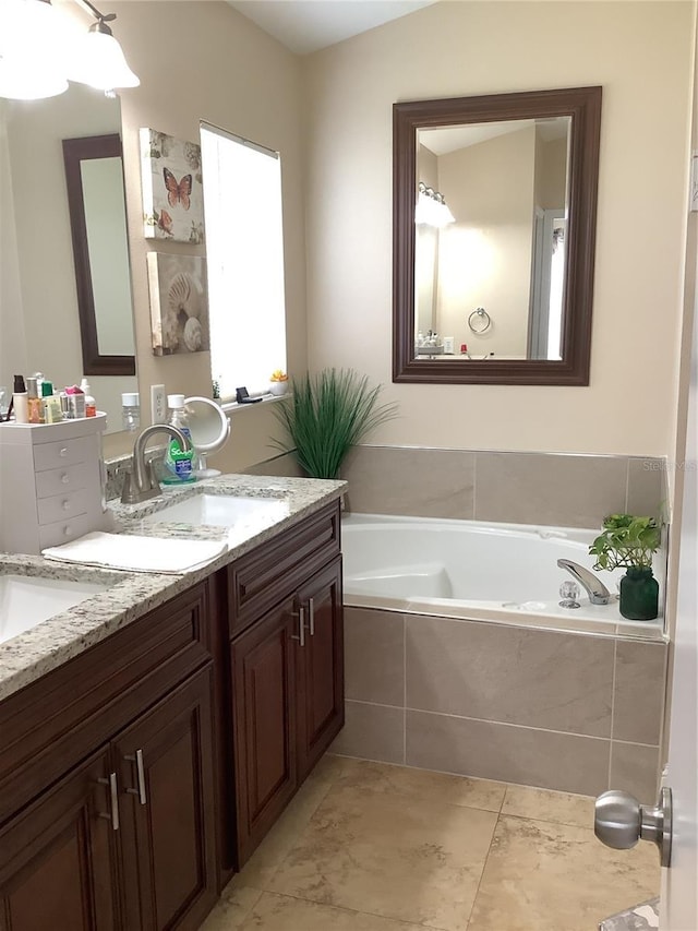 bathroom featuring vanity and tiled tub