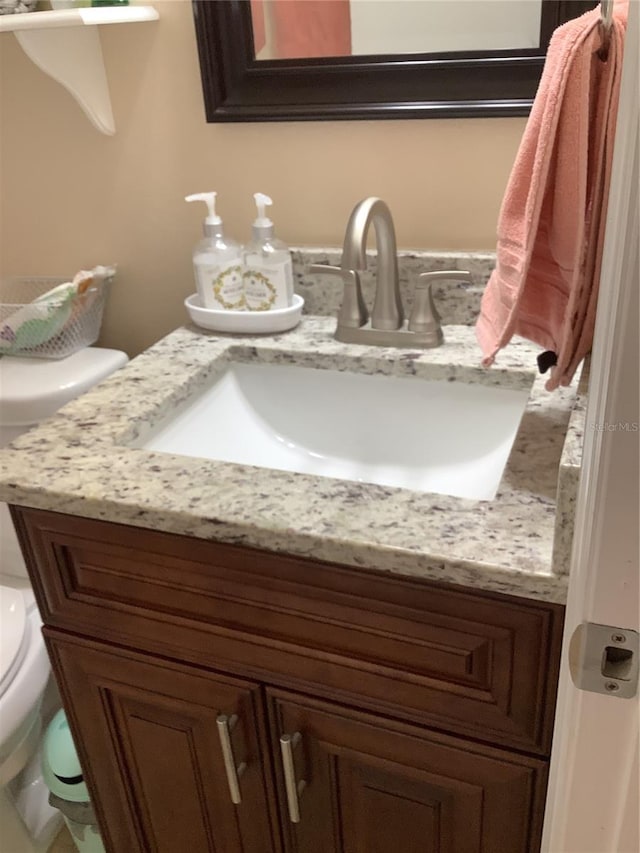 bathroom with vanity and toilet