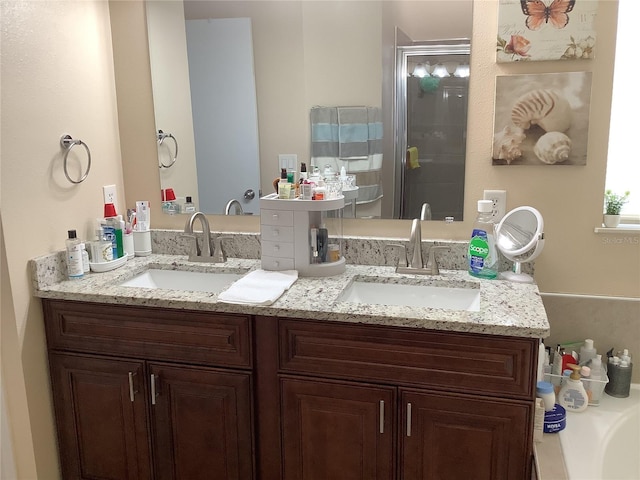 bathroom featuring vanity and an enclosed shower