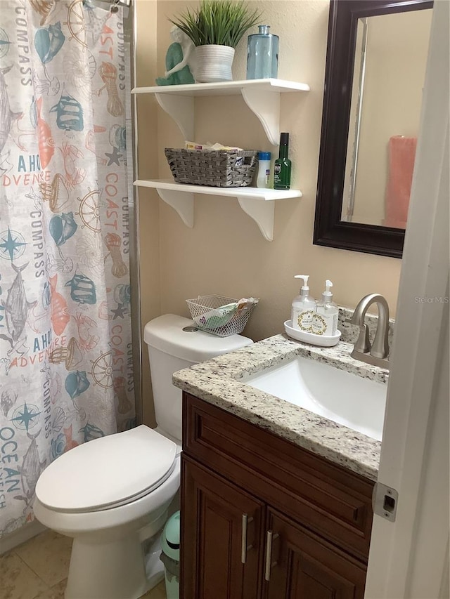 bathroom featuring vanity, a shower with curtain, tile patterned floors, and toilet