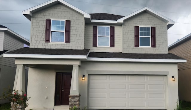 craftsman house featuring roof with shingles, an attached garage, and stucco siding