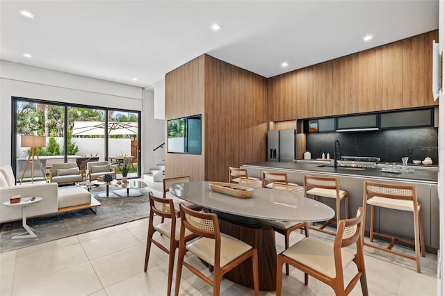 dining room with sink and light tile patterned flooring