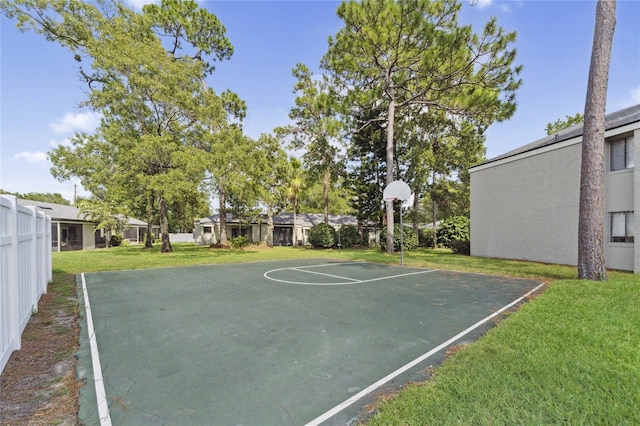 view of basketball court featuring a yard