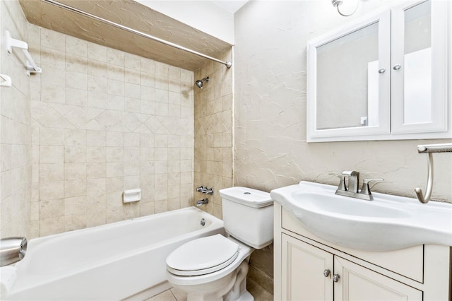 full bathroom featuring toilet, vanity, and tiled shower / bath