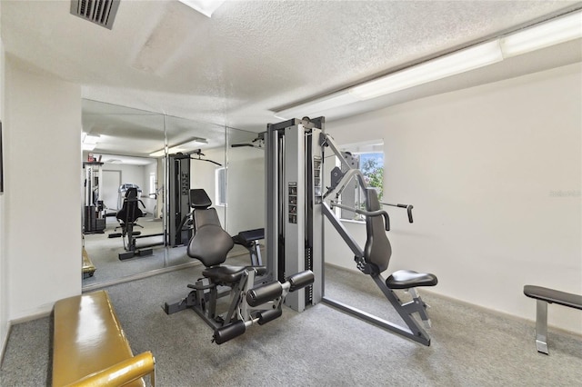 exercise room featuring a textured ceiling