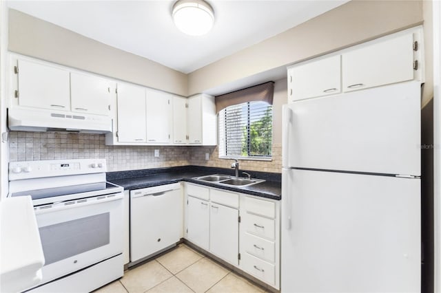 kitchen with light tile patterned floors, tasteful backsplash, sink, white appliances, and white cabinetry