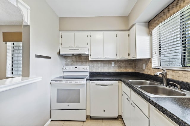 kitchen featuring white appliances, sink, backsplash, light tile patterned floors, and white cabinetry