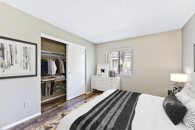 bedroom featuring a closet, dark hardwood / wood-style flooring, and a textured ceiling