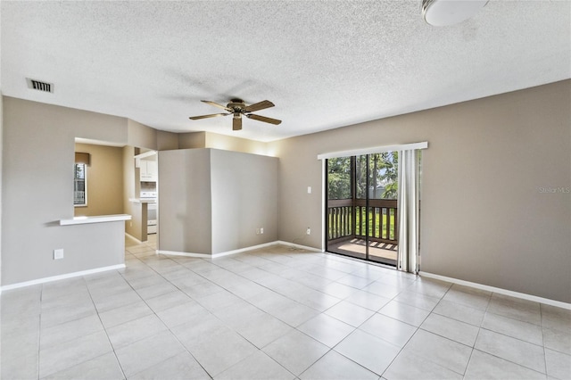 unfurnished room with ceiling fan, a textured ceiling, and light tile patterned floors