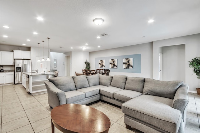 living area featuring light tile patterned floors and recessed lighting