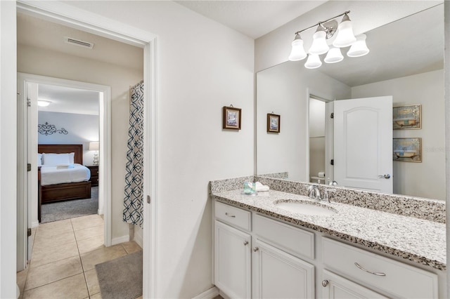 bathroom featuring tile patterned flooring and vanity