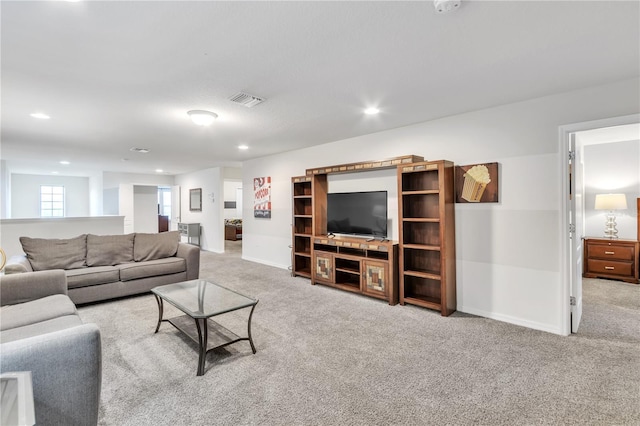 carpeted living room featuring baseboards, visible vents, and recessed lighting