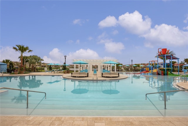 community pool with a water play area and a water slide