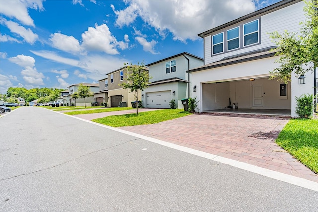 view of front of house featuring a garage and a front lawn