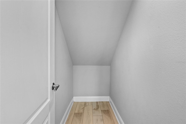 spacious closet with lofted ceiling and hardwood / wood-style floors