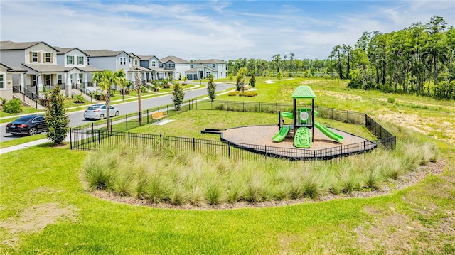 view of home's community with a playground and a lawn