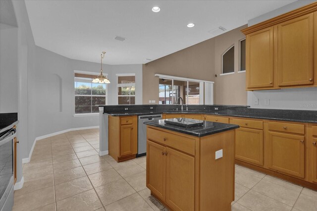 kitchen featuring light tile patterned flooring, a center island, decorative light fixtures, and stainless steel dishwasher