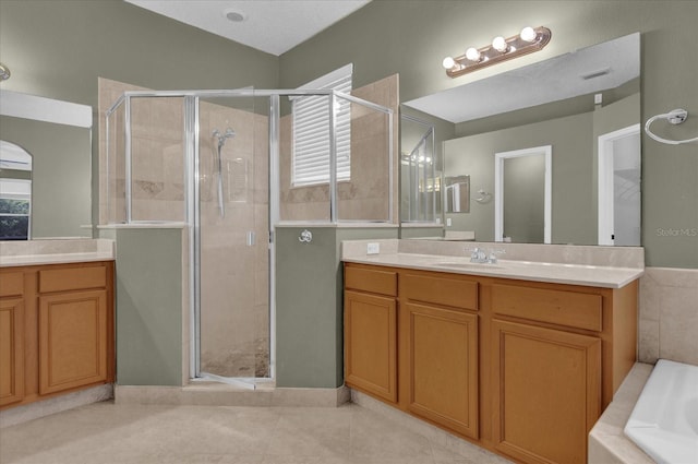 bathroom with vanity, independent shower and bath, and tile patterned flooring