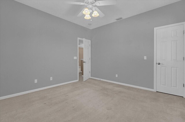 carpeted spare room featuring ceiling fan