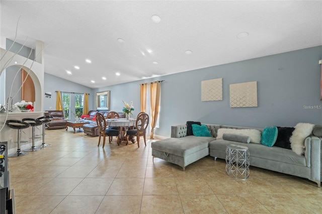 living room featuring lofted ceiling, french doors, light tile patterned flooring, and recessed lighting