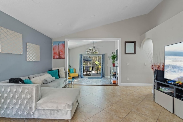 living area with lofted ceiling, light tile patterned flooring, arched walkways, and baseboards