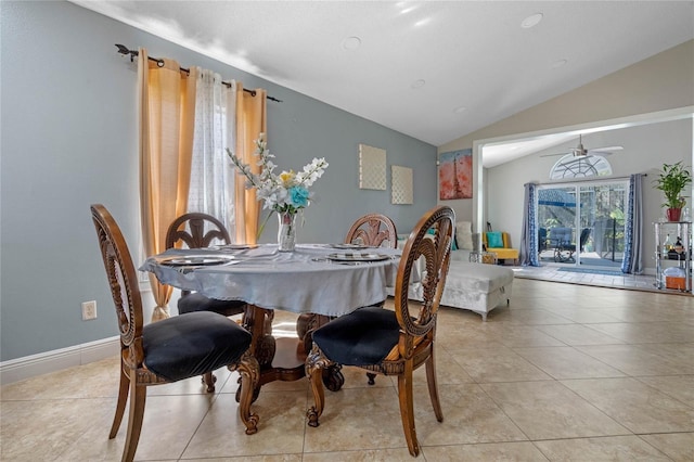 tiled dining area featuring ceiling fan and vaulted ceiling