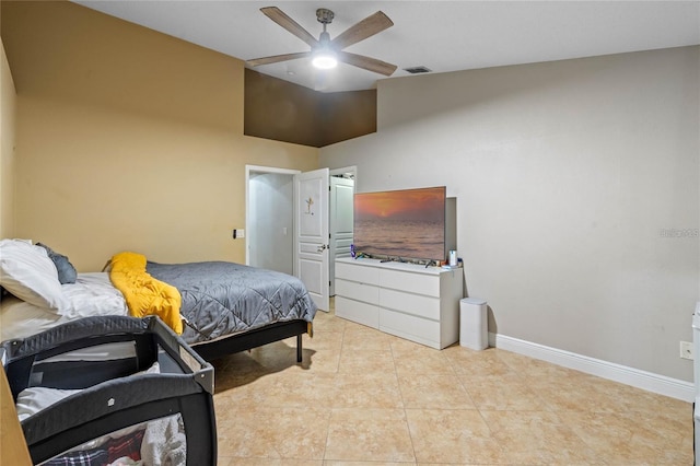 bedroom featuring a ceiling fan, visible vents, baseboards, and light tile patterned floors