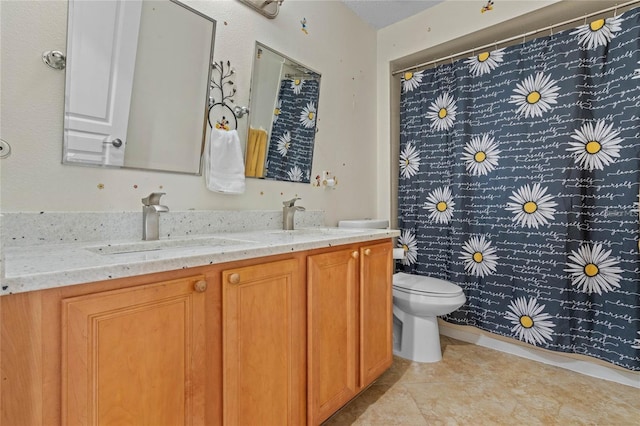 bathroom featuring double vanity, a shower with shower curtain, a sink, and toilet