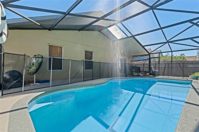 view of swimming pool featuring a patio area and a lanai