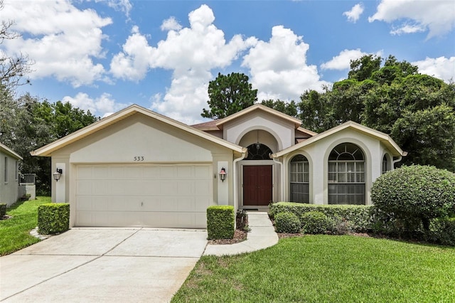 single story home featuring a garage and a front lawn