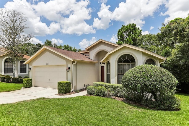 ranch-style house with a garage and a front lawn