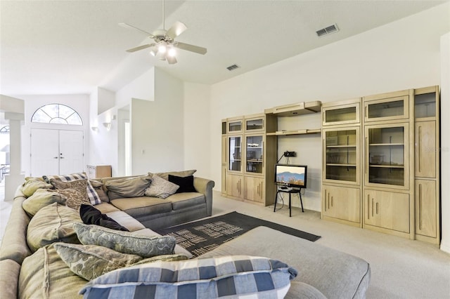 living room with light carpet, vaulted ceiling, and ceiling fan