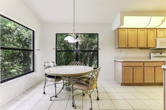 dining area with light tile patterned floors and a chandelier