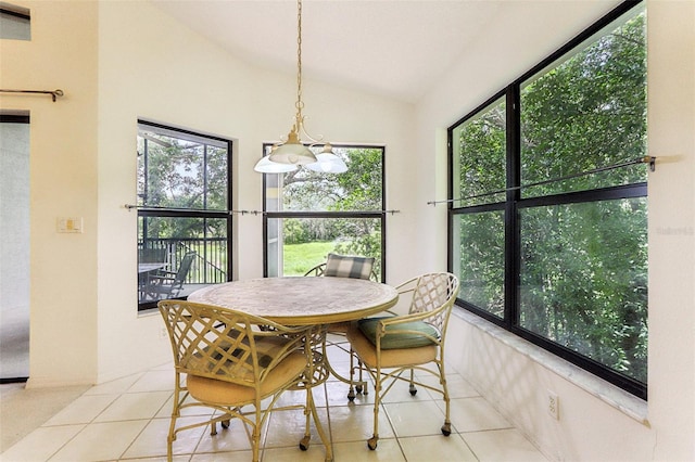 tiled dining room with vaulted ceiling