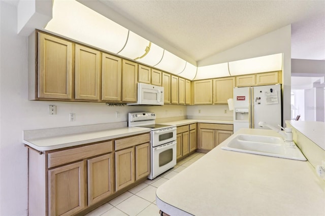 kitchen featuring sink, white appliances, light tile patterned floors, a textured ceiling, and vaulted ceiling