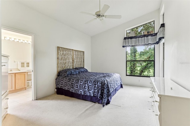 carpeted bedroom featuring ceiling fan, ensuite bath, and multiple windows