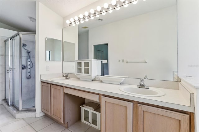 bathroom with tile patterned floors, a shower with door, vanity, and a textured ceiling