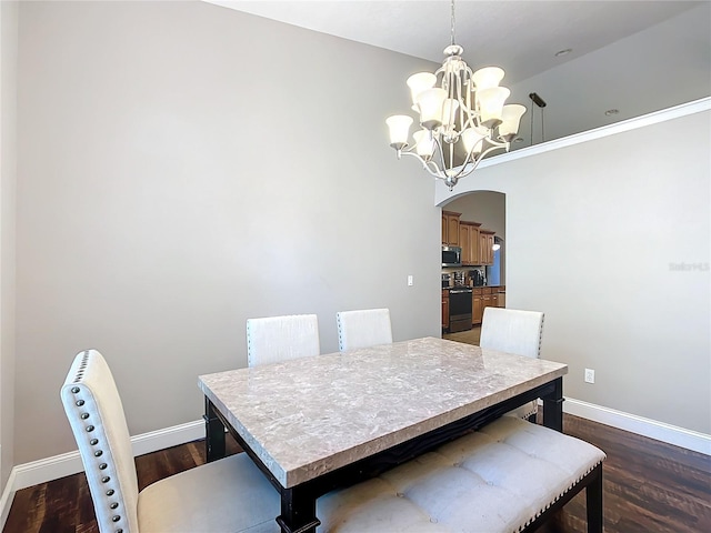 dining area featuring an inviting chandelier and dark wood-type flooring