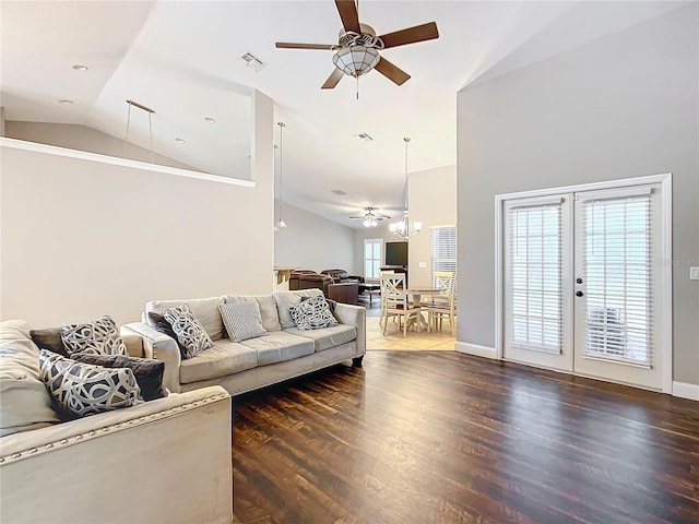 living room featuring dark wood-type flooring, french doors, ceiling fan, and lofted ceiling