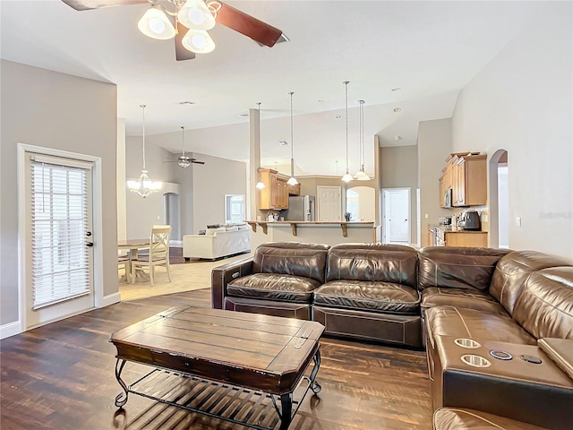 living room with wood-type flooring, ceiling fan, and high vaulted ceiling