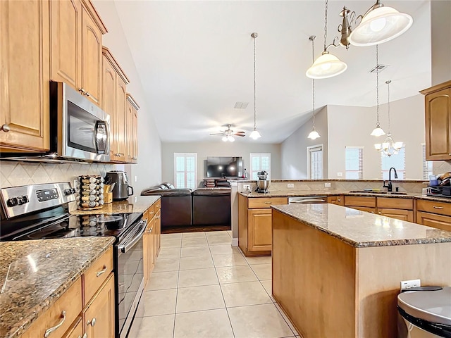 kitchen featuring decorative light fixtures, light tile patterned flooring, ceiling fan with notable chandelier, appliances with stainless steel finishes, and backsplash